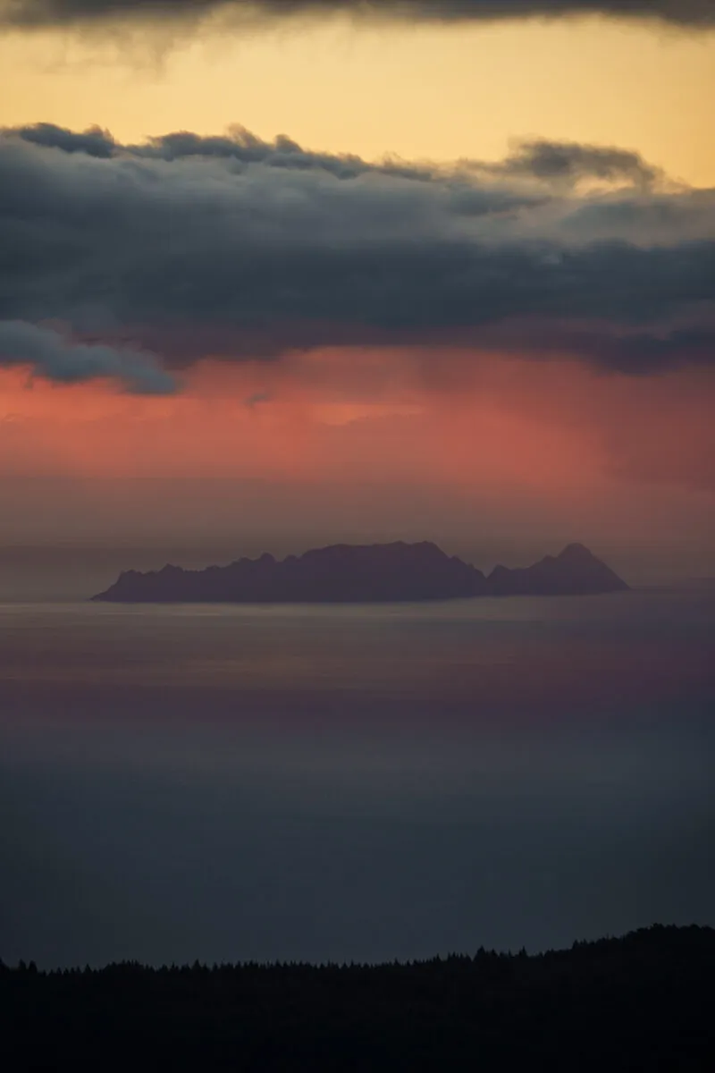 Island silhouette in coral mist